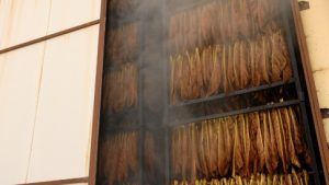 Fire-curing tobacco leaves