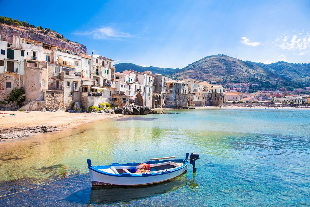 Enjoying a Parodi Cigar at an Beautiful old harbor with wooden fishing boat in Cefalu, Sicily, Italy.